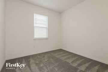 Bartow house for rent - the living room of a home with carpet and a window