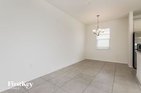 Bartow house for rent - A spacious room with a chandelier and a window.