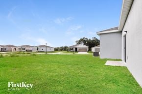 Bartow house for rent - A grassy field with a FirstKey Homes logo.