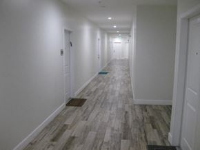 Reseda apartment for rent - A long hallway with wood flooring and white walls.