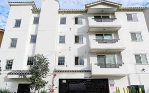 Reseda apartment for rent - A white building with black doors and windows.
