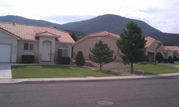 Cedar City apartment for rent - a house on a street with a mountain in the background