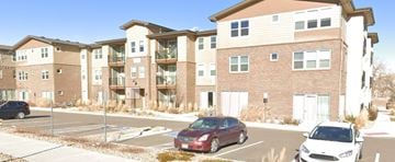 Arvada house for rent - an apartment building with cars parked in a parking lot