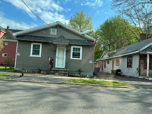 Syracuse apartment for rent - a gray house with a street in front of it