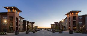 Papillion apartment for rent - a row of apartment buildings at sunset with the sky in the background