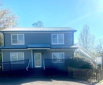 Atlanta house for rent - A grey house with a black fence and a white door.