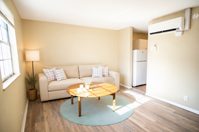 Knoxville apartment for rent - A living room with a couch, a table, and a plant.