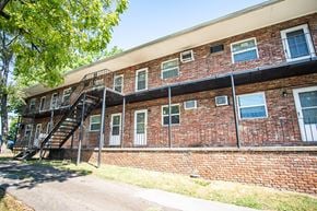 Knoxville apartment for rent - A red brick building with a balcony and stairs.