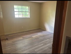 Knoxville apartment for rent - A room with a window and wooden flooring.