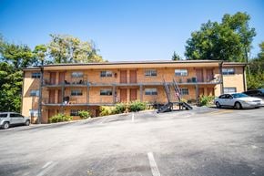 Knoxville apartment for rent - A parking lot in front of a two-story apartment building.