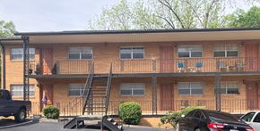 Knoxville apartment for rent - A brown building with a black truck parked in front.
