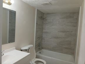 Knoxville apartment for rent - A bathroom with a white toilet and a white sink.