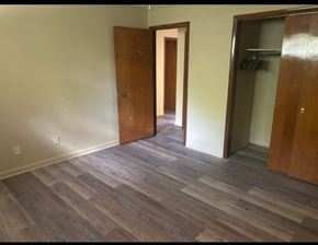Knoxville apartment for rent - A room with a wooden floor and two wooden doors.
