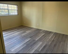 Knoxville apartment for rent - A room with wooden flooring and a window.