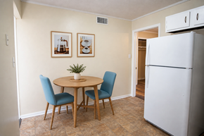 Knoxville apartment for rent - A kitchen with a white refrigerator and a table with four chairs.