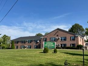 Xenia apartment for rent - A building with a sign that says Greene Meadows in front of it.
