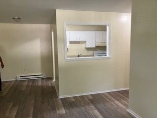 Xenia apartment for rent - A room with a kitchen in the background and a window.
