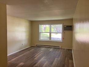 Xenia apartment for rent - A room with a window and a radiator on the wall.