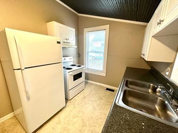 Greenville house for rent - a kitchen with a sink and a refrigerator