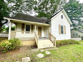 Greenville house for rent - a small white house with a porch and