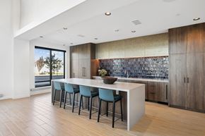 West Jordan apartment for rent - a kitchen with an island and blue stools in front of a large