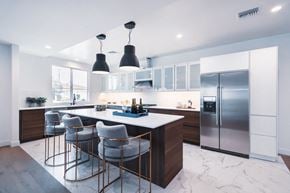 Los Angeles house for rent - A modern kitchen with a bar area and stools.
