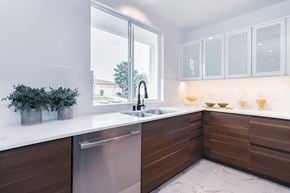 Los Angeles house for rent - A modern kitchen with a stainless steel dishwasher and wooden cabinets.