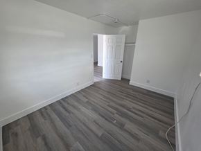 Fort Myers apartment for rent - A room with wooden flooring and a white door.