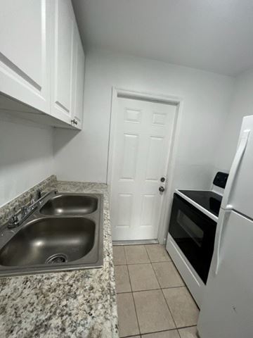 Fort Myers apartment for rent - A kitchen with a sink and a refrigerator.