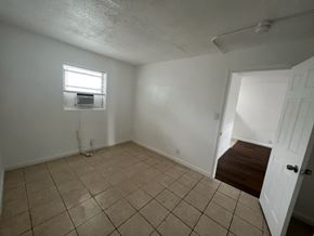 Fort Myers apartment for rent - A room with a tiled floor and a window.