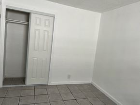 Fort Myers apartment for rent - A white door is open in a room with white walls.