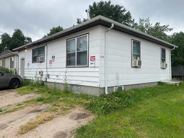 Kearney apartment for rent - a white house with a car parked in front of it