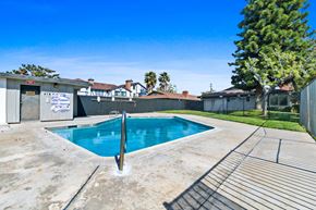 Stanton apartment for rent - a swimming pool in a backyard with a fence and a tree