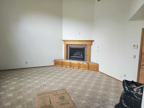Dallas house for rent - an empty living room with a fireplace in it