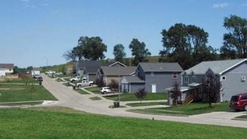 Winnebago apartment for rent - a neighborhood of houses with cars parked in the street