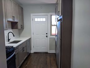 Evanston apartment for rent - an empty kitchen with a white door and a window