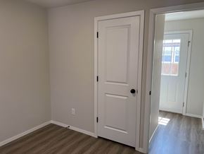 Shawnee house for rent - A white door is in a room with light colored walls.