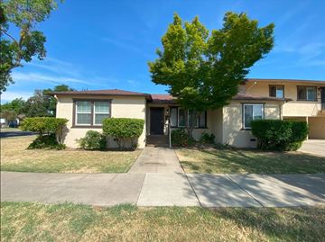 Merced house for rent - A house with a brown roof and a tree in front.