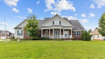 Fayetteville house for rent - a large house with a lawn in front of it