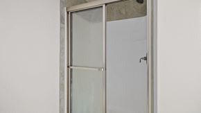 Fayetteville house for rent - a glass shower door in a white bathroom