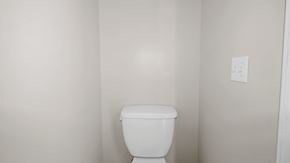 Fayetteville house for rent - an empty bathroom with a toilet and a white wall