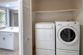 Vestal apartment for rent - A white washing machine and dryer in a laundry room.