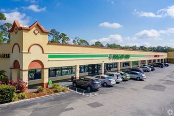 Kissimmee apartment for rent - the exterior of a shopping center with cars parked in front of it