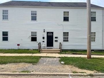 Kingsport apartment for rent - the front of a white house with a black door