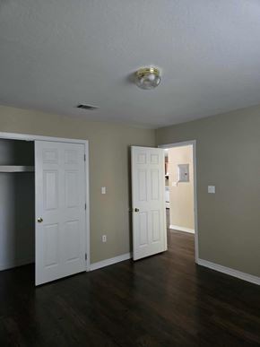 Hattiesburg apartment for rent - A room with two white doors and a light on the ceiling.