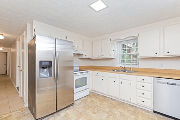 Nashville apartment for rent - A kitchen with a stainless steel refrigerator and white cabinets.