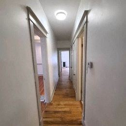 Louisville apartment for rent - a hallway with white walls and a wood floor