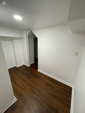 Louisville apartment for rent - a renovated living room with white walls and wood flooring