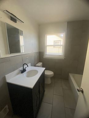 Louisville apartment for rent - A bathroom with a sink, toilet, and bathtub.