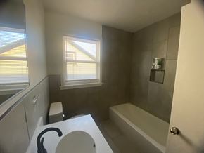 Louisville apartment for rent - A bathroom with a toilet, sink, and bathtub.